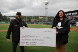Richard Hart presents a check for the Wounded Warrior Project at a Tacoma Rainiers game.