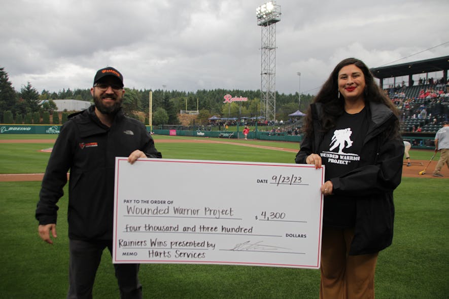 Richard Hart presents a check for the Wounded Warrior Project at a Tacoma Rainiers game.