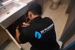 Zo Plumbing Tech Working On Job Zo Plumbing Tech Working On Job