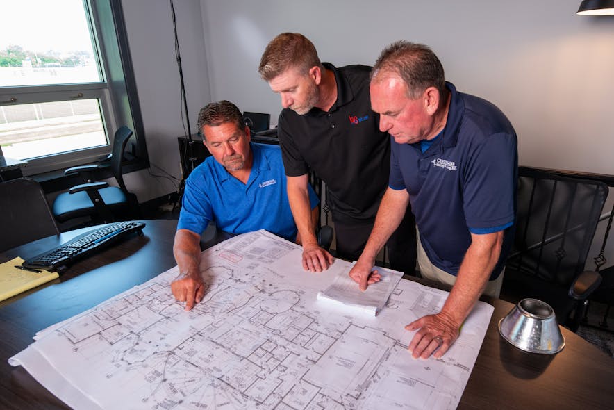 (Left to right) Jeremy Gillette, owner of Center Line, Jarrett Armstrong, VP of commercial sales at HS/Buy Van Associates, and Kevin Roberts Center Line project manager look at project blueprints.