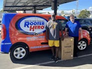 Rooter Hero volunteers donate a ice maker to a local high school.