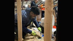 A plumbing trainee learning the trade. A plumbing trainee learning the trade.