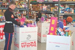 A US Marine helps sort boxes of presents. A US Marine helps sort boxes of presents.