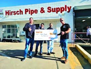 Tyler Rygh (far right) of All Coast Plumbing &amp; Rooter accepts $10,000 grand prize in Noritz&rsquo;s Retrofit Rewards promotion from Noritz SoCal Territory manager Dylan Stieler (far left).