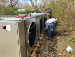 NMD technicians remove the fans and motors of the fluid cooler to prep for installation. NMD technicians remove the fans and motors of the fluid cooler to prep for installation.