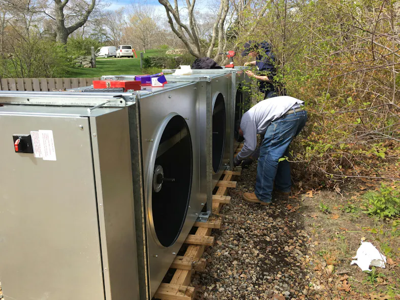 NMD technicians steal away the followers and motors of the fluid cooler to prep for installation. NMD technicians steal away the followers and motors of the fluid cooler to prep for installation.