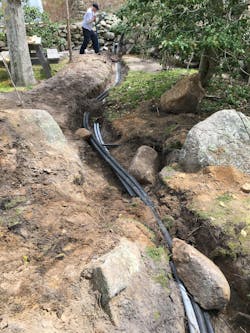 Supply and return HDPE piping between the fluid cooler and the carriage house mechanical room. Supply and return HDPE piping between the fluid cooler and the carriage house mechanical room.