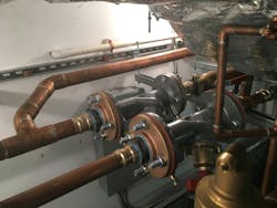 Main house mechanical room with balancing valves, fluid cooler loop and main house loop. Main house mechanical room with balancing valves, fluid cooler loop and main house loop.