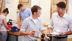 Young students learning the plumbing trade in a classroom setting. Young students learning the plumbing trade in a classroom setting.