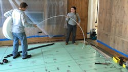 NMD technicians install Uponor PEX tubing into Warmboard panels. NMD technicians install Uponor PEX tubing into Warmboard panels.