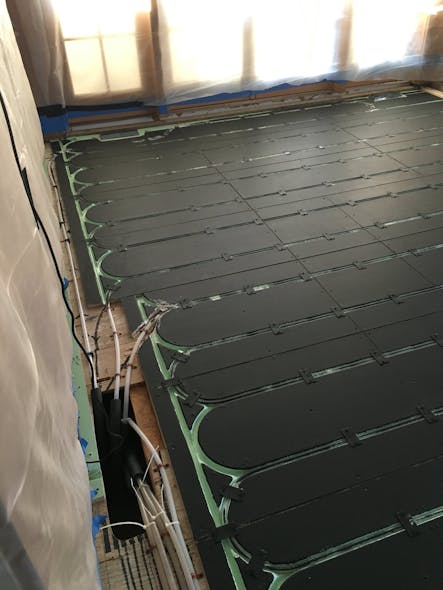 PEX tubing and Warmboard painted flat black to increase radiant heat transfer to the floating floor.