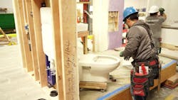 An in-wall carrier system being installed. An in-wall carrier system being installed.