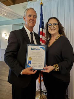 Matt Hinson (left) receives the Doctor of Water degree from SCWUA President, Stephanie Moreno. Matt Hinson (left) receives the Doctor of Water degree from SCWUA President, Stephanie Moreno.