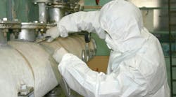 Worker taking an asbestos sample.