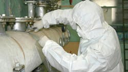 Worker taking an asbestos sample. Worker taking an asbestos sample.