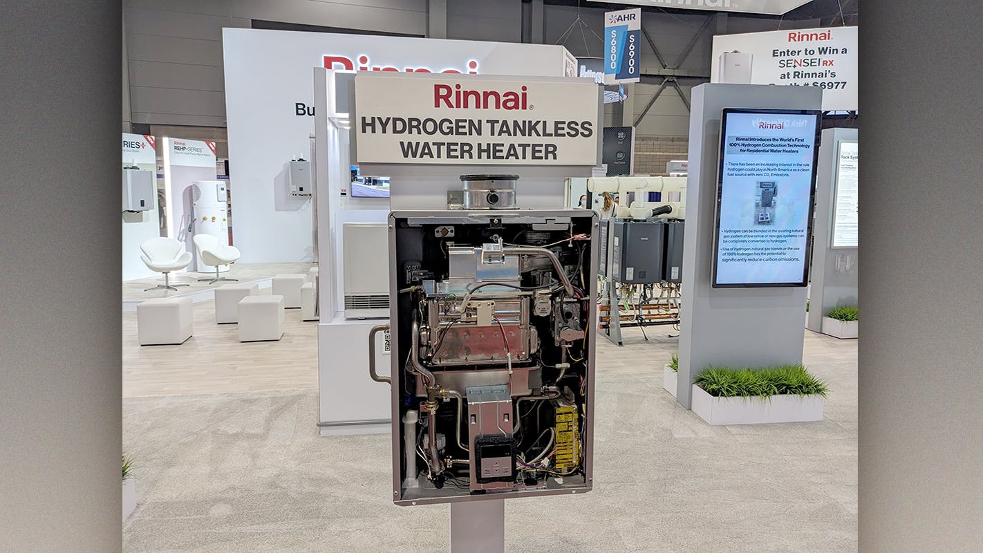 A hydrogen-powered tankless water heater, with the cover off, on display at the Rinnai booth during AHR Expo 2024.
