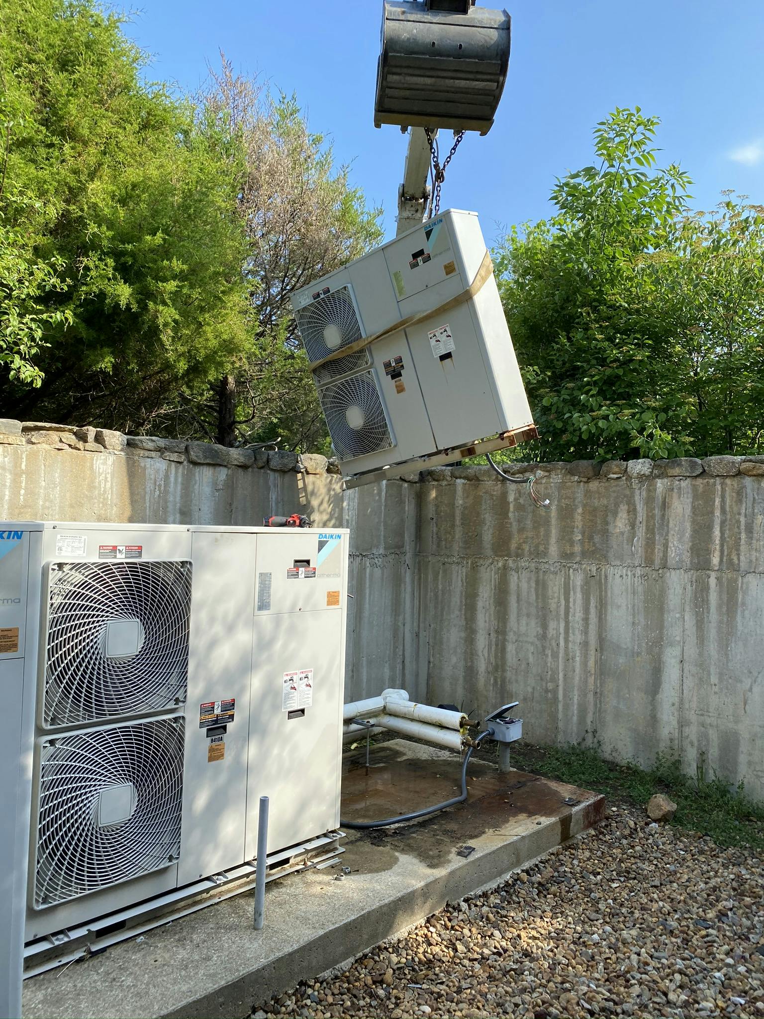 A Daikin Altherma being lifted out.