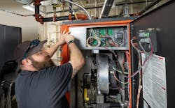 Tony Cornett, one of the district’s HVAC technicians, services an Arctic condensing boiler at Endeavor Elementary. Tony Cornett, one of the district’s HVAC technicians, services an Arctic condensing boiler at Endeavor Elementary.