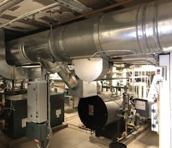 Old boilers and breeching in the mechanical room. Old boilers and breeching in the mechanical room.