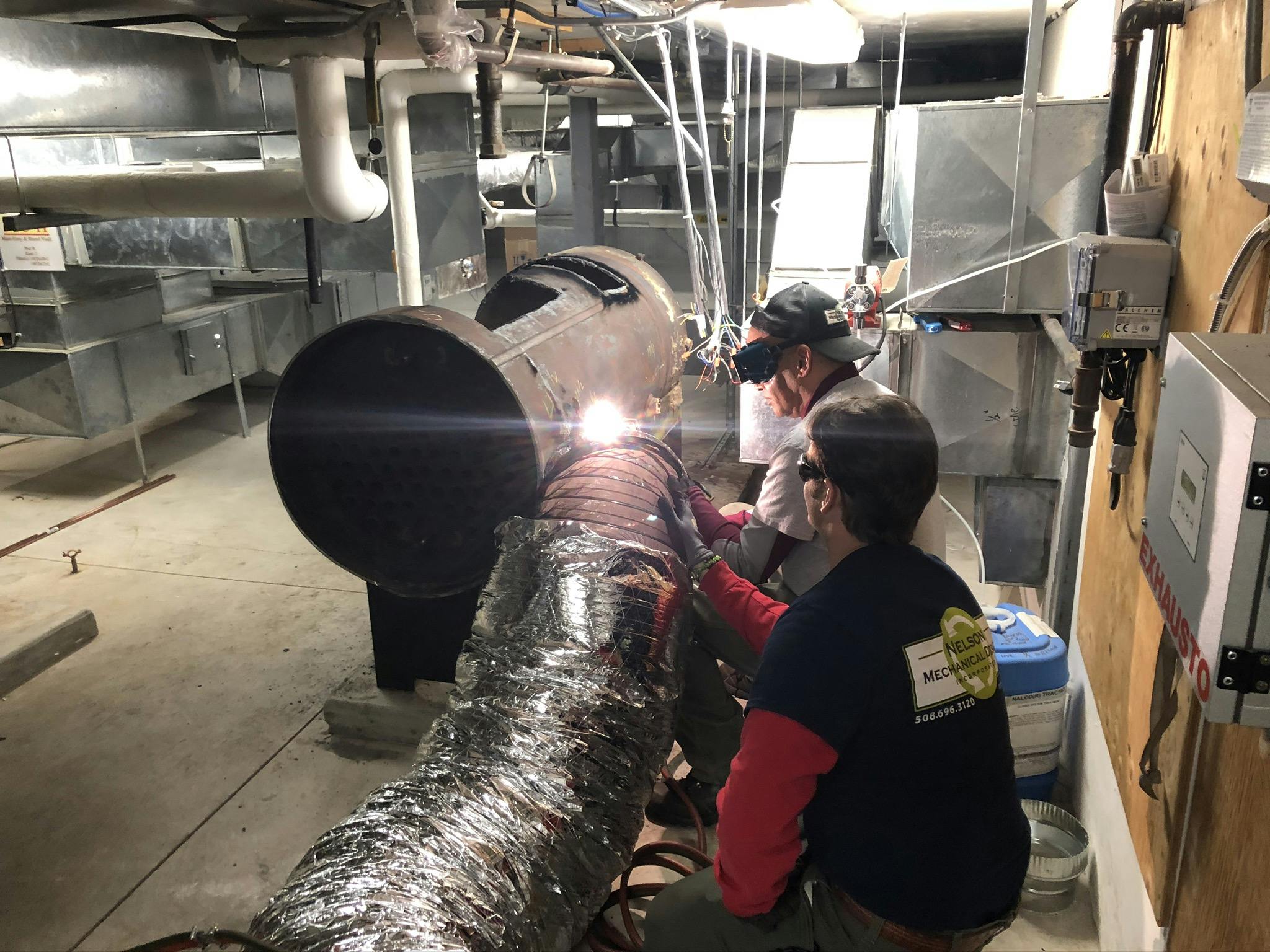 Cutting up the old boiler for removal.