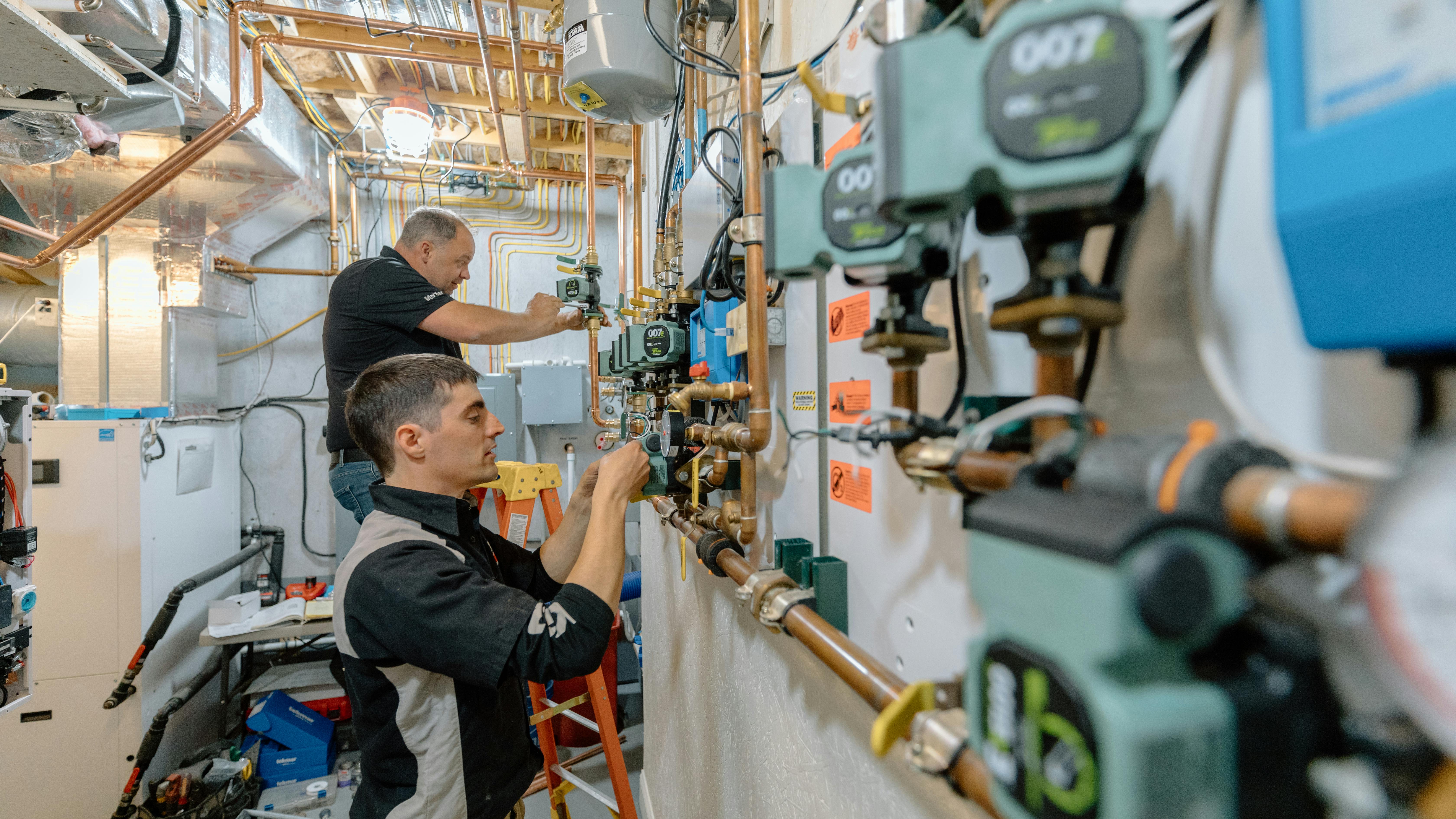 Vertex Mechanical president Vince Youndt (left) and jobsite supervisor Jared Fox set Taco ECM circulator during the renovation project.
