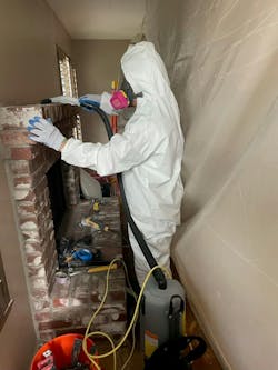 A DRYmedic Restoration Services technician (California) is equipped with personal protection equipment while cleaning a customer&rsquo;s home.