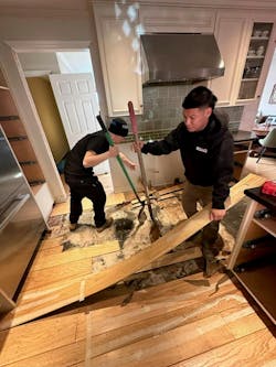 Technicians with John Rossi&rsquo;s DRYmedic Restoration Services in California remove a customer&rsquo;s kitchen floor after water damage.