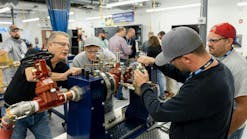A senior instructor helps trainees get hands-on. Over the last decade, Watts Water Technologies has invested tens of millions into training and education.