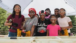 Tools &amp; Tiaras Founder/CVO, Judaline Cassidy, with a group of Summer Campers during a carpentry workshop.