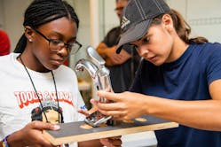 Tools &amp; Tiaras Summer Campers, Paige (left) and Izzy (right), hard at work on a faucet install during a plumbing workshop.