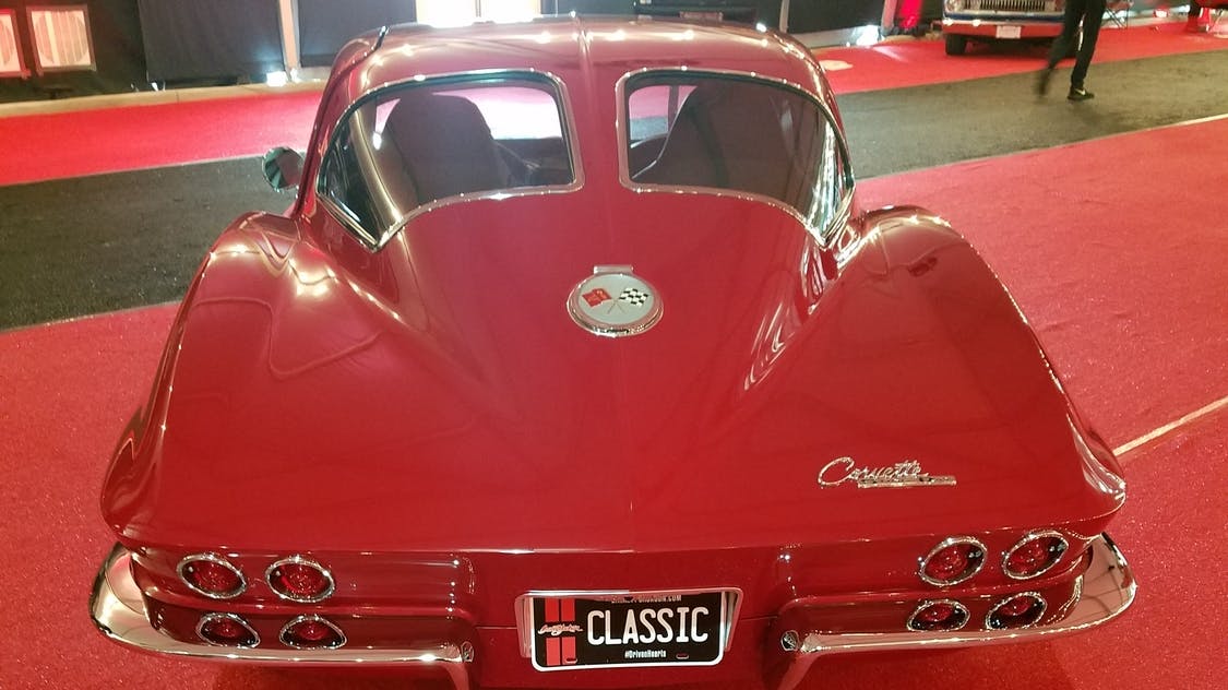 The back end of a 1963 Corvette with its distinctive twin rear window.