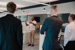 Derrick Johnson, Organizational Change Management Manager at Ferguson, takes scholarship recipients on a tour of Ferguson's facilities, providing insight into the professional world they are about to enter, thanks to the American Industries Trade Scholarship. Derrick Johnson, Organizational Change Management Manager at Ferguson, takes scholarship recipients on a tour of Ferguson's facilities, providing insight into the professional world they are about to enter, thanks to the American Industries Trade Scholarship.