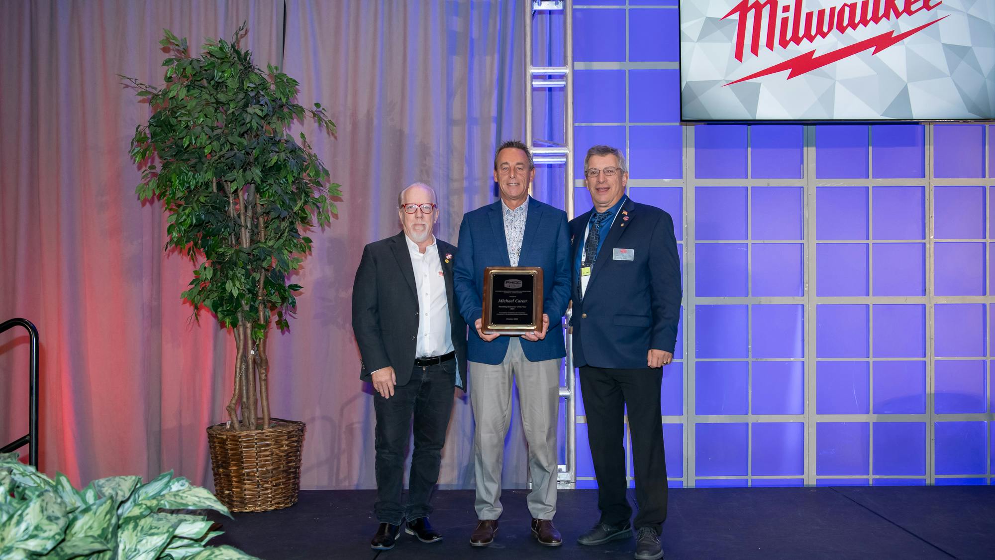 Michael Carter (center), PHCC's Plumbing Instructor of the Year.