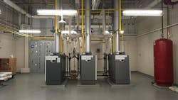 High-efficiency boilers in a mechanical room. High-efficiency boilers in a mechanical room.