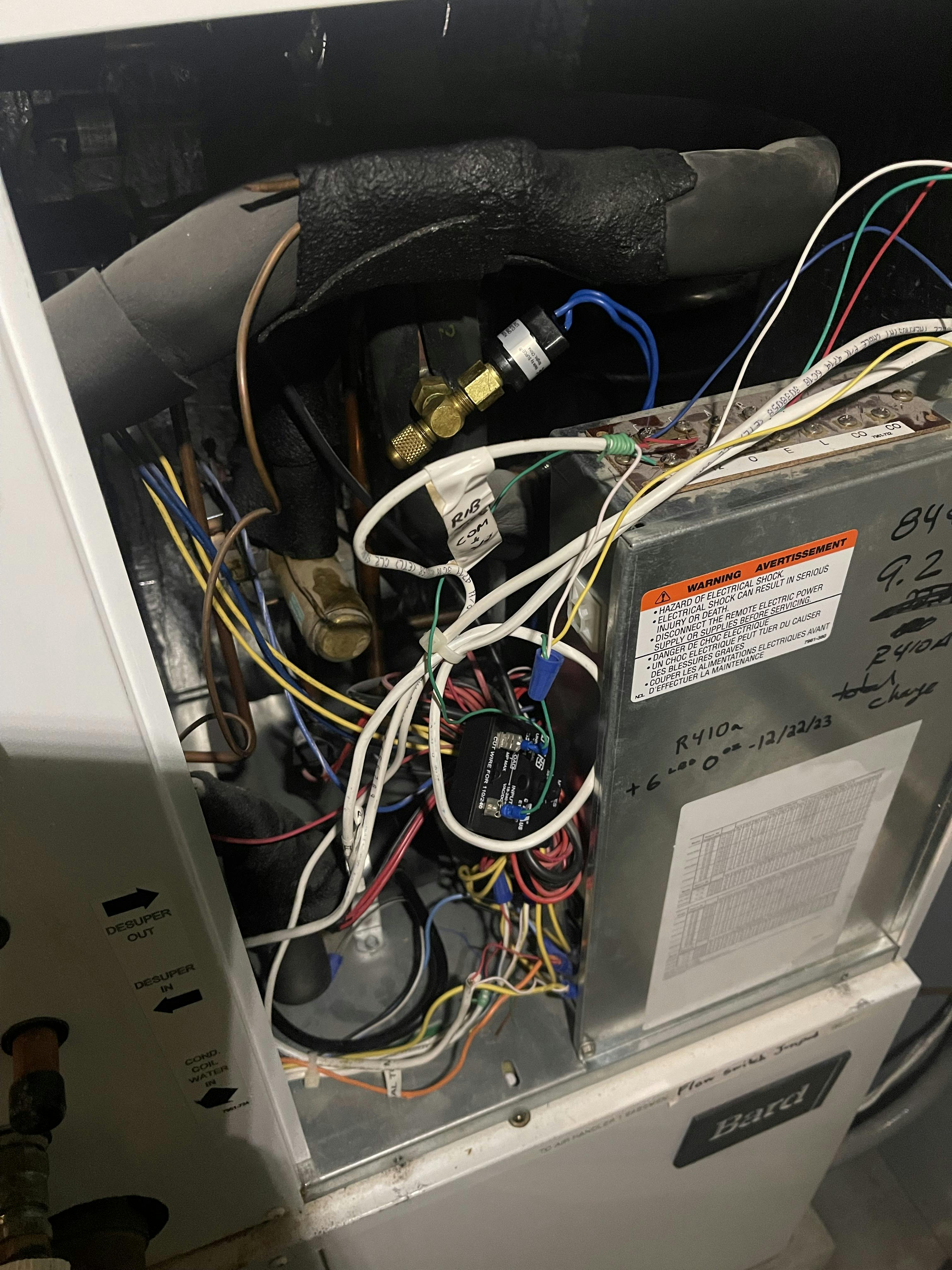 A new refrigerant pressure switch connected to a tee fitting.