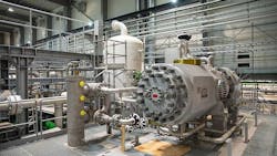 An industrial heat pump set-up, with the compressor in the foreground. An industrial heat pump set-up, with the compressor in the foreground.