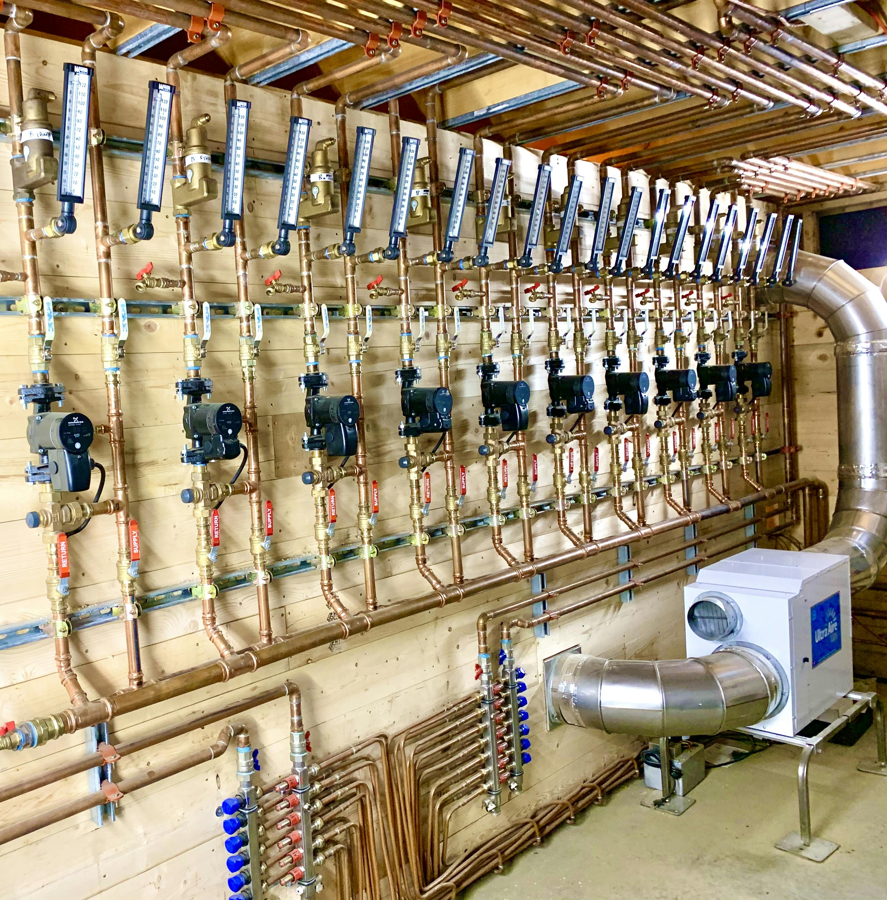 Radiant pump stations in the main mechanical room, alongside the dehumidifier.