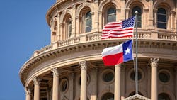 American and Texas state flags flying on the dome of the Texas State Capitol building in Austin. American and Texas state flags flying on the dome of the Texas State Capitol building in Austin.