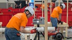 Competitors in the plumbing competition fit sections of PVC pipe during the 36th National Craft Competition. Competitors in the plumbing competition fit sections of PVC pipe during the 36th National Craft Competition.