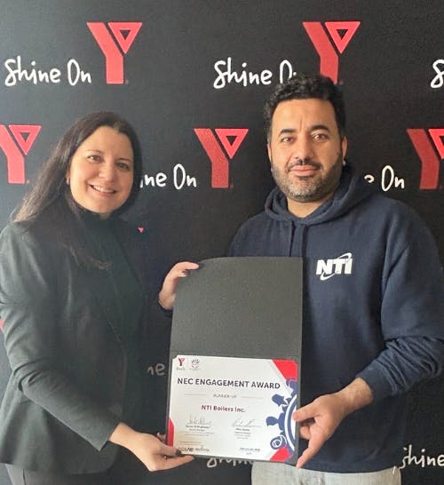 Vanessa De Salvo Pineda, left, NTI Human Resources, and NTI Plant Director Fahad Khan accept the NEC Engagement Award on behalf of NTI Boilers, Inc.