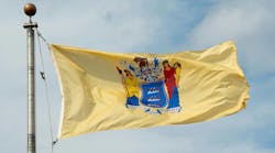 New Jersey state flag flies over the state capitol in Trenton. New Jersey state flag flies over the state capitol in Trenton.