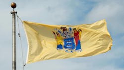 New Jersey state flag flies over the state capitol in Trenton. New Jersey state flag flies over the state capitol in Trenton.