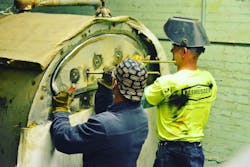 Working on a boiler. Working on a boiler.