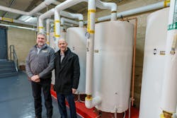 (Left to right) Kevin Gauthier of Laars Heating Systems and Greg Rathe of Rathe Associates standing in front of Laars Stratified Storage Tanks. (Left to right) Kevin Gauthier of Laars Heating Systems and Greg Rathe of Rathe Associates standing in front of Laars Stratified Storage Tanks.