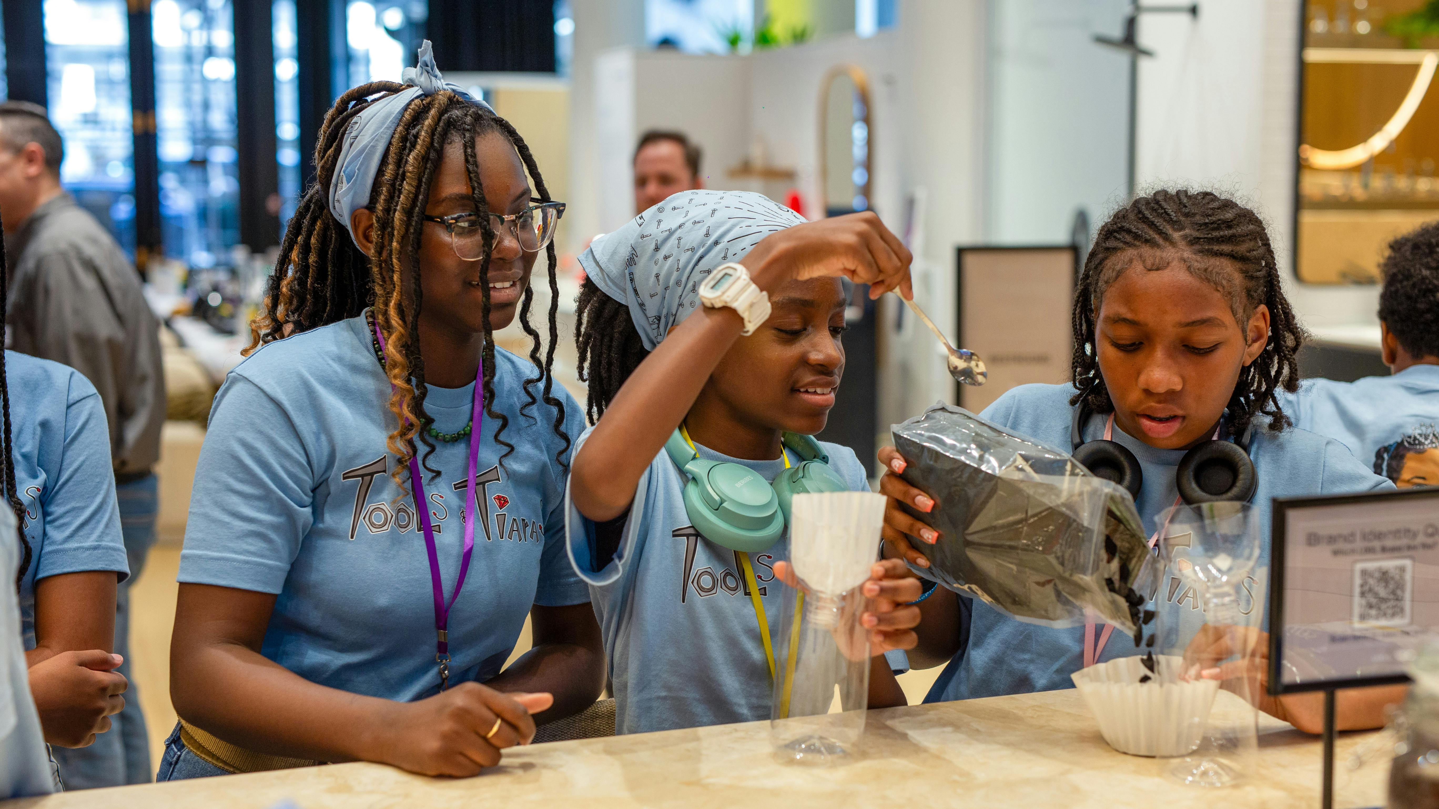 Campers at the workshop perform a water filtration experiment.
