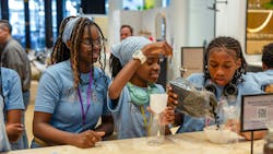 Campers at the workshop perform a water filtration experiment. Campers at the workshop perform a water filtration experiment.