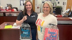 Two Air Pros USA employees at Pembroke Pines Elementary with bags of school supplies. Two Air Pros USA employees at Pembroke Pines Elementary with bags of school supplies.