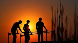 Construction workers at sunset. Construction workers at sunset.