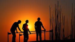 Construction workers at sunset. Construction workers at sunset.