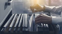 Office clerk searching files in the filing cabinet. Office clerk searching files in the filing cabinet.
